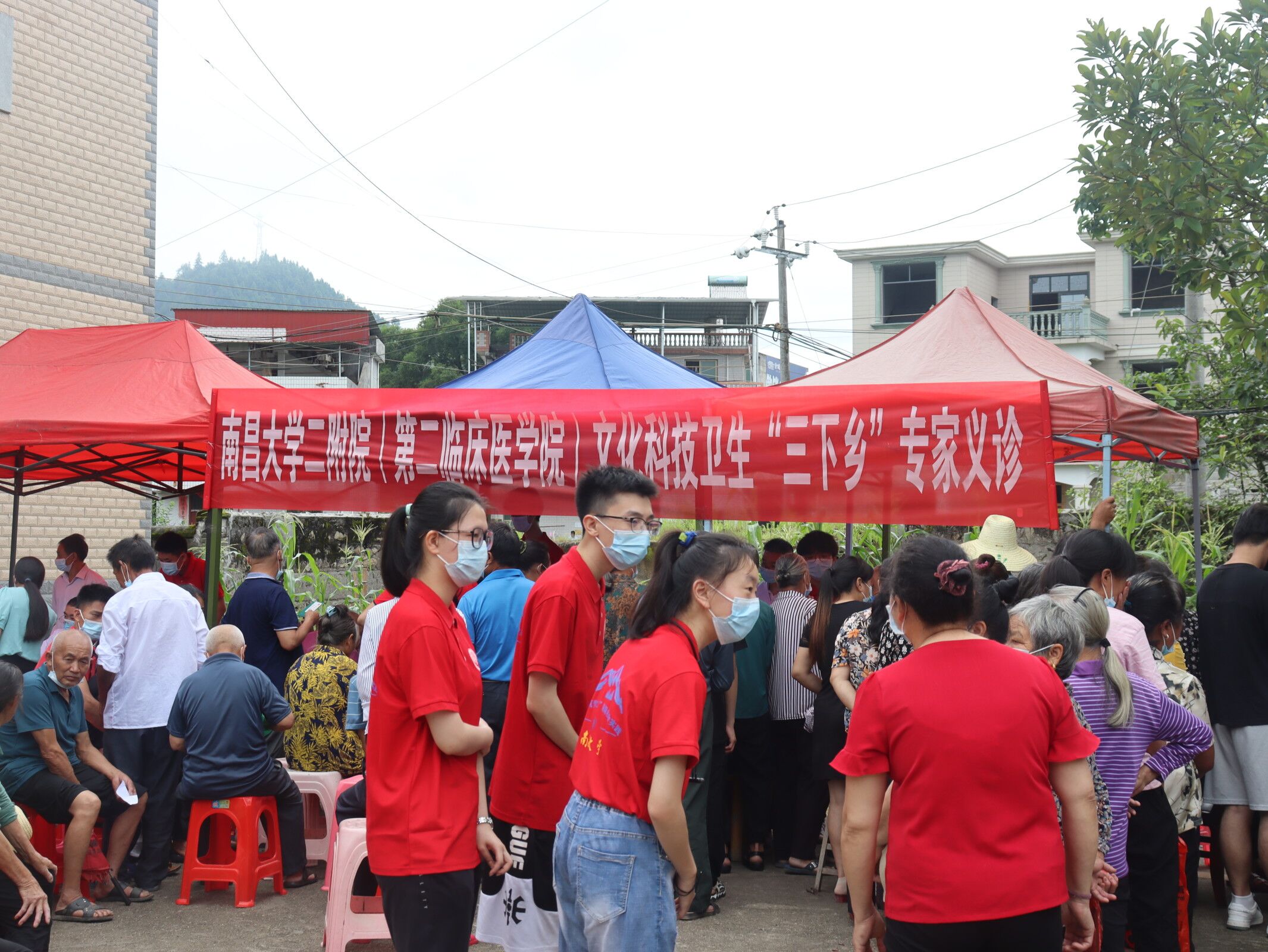 图为实践队员根据村民主诉进行预诊，并引导至相应专家处进行进一步诊断。