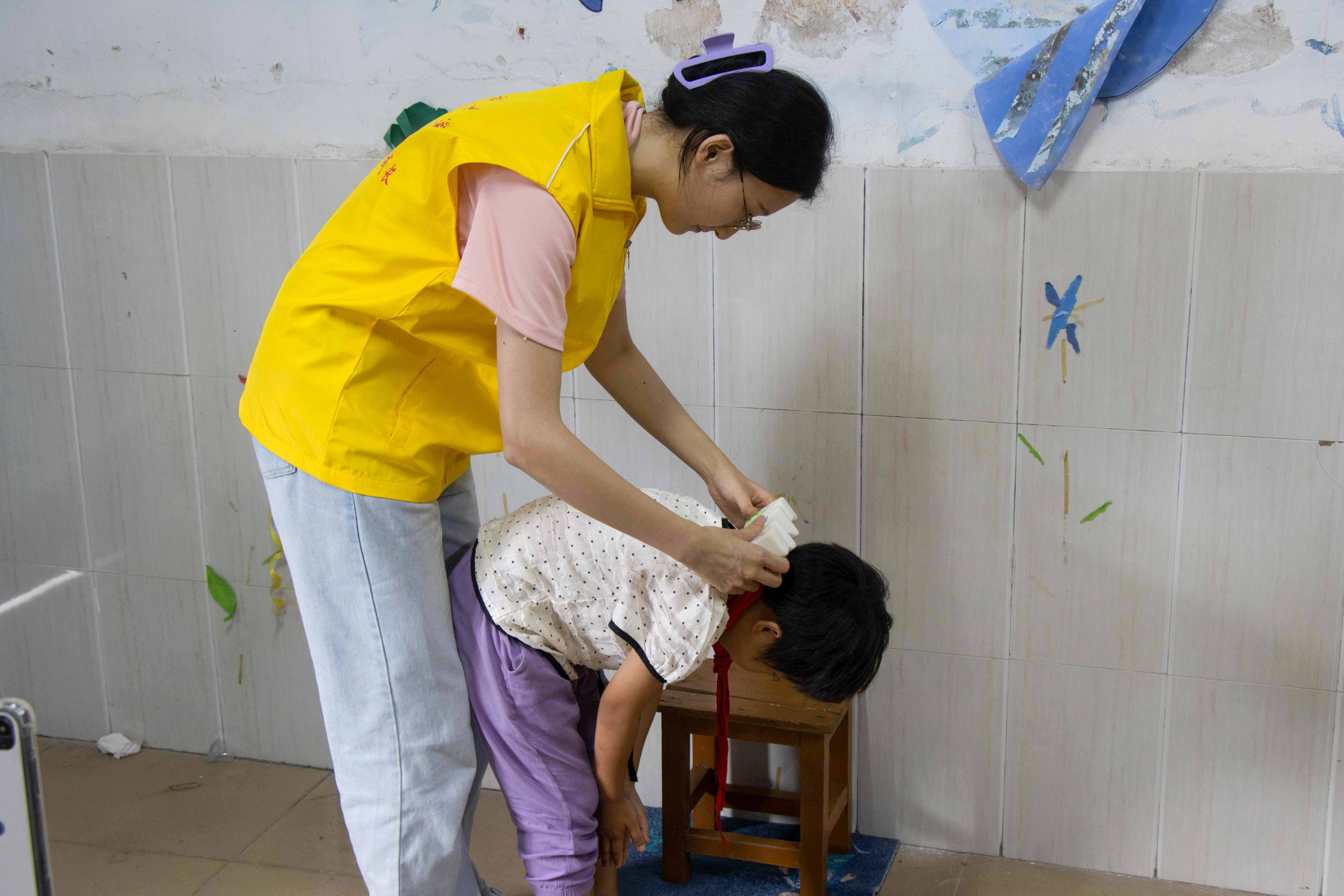 图为服务队队员利用仪器为小朋友们进行脊柱侧弯筛查。 冯家祥 供图