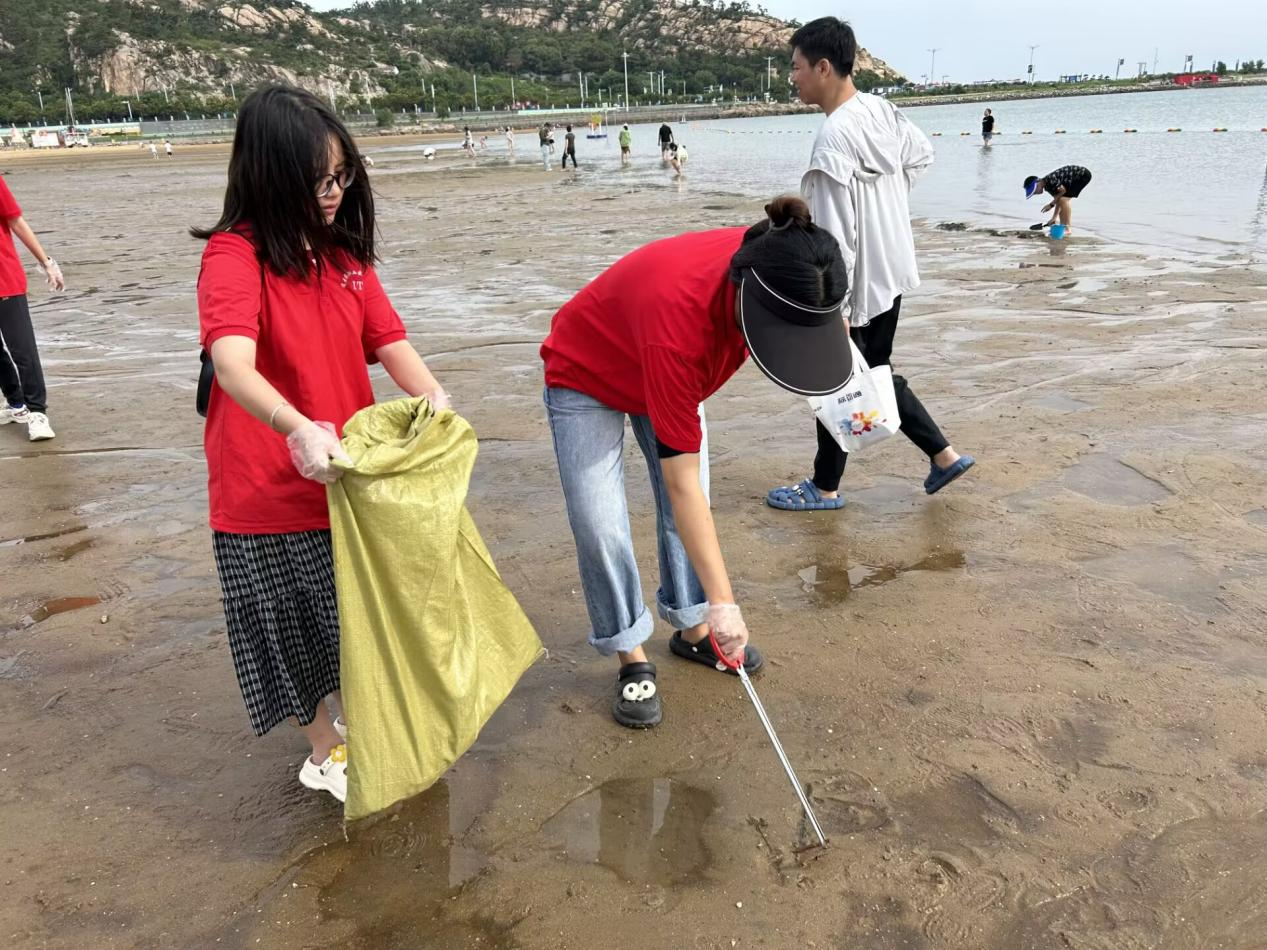 图为团队成员在海水退潮后于沙滩上捡拾垃圾。孙含雪供图