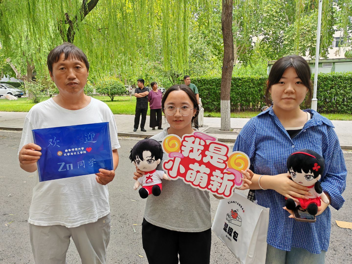 新生与家长拿着小中合照