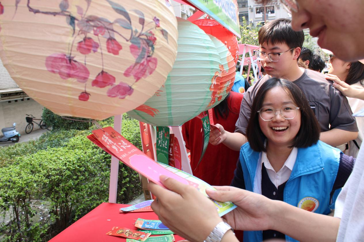 学生在古风灯谜长廊猜灯谜.png